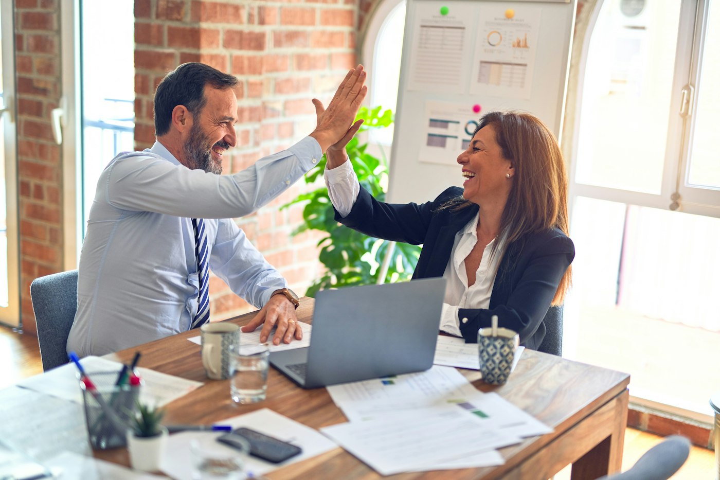 Advisors reviewing documents together at a bright table